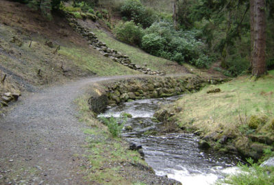 River with mossy wall