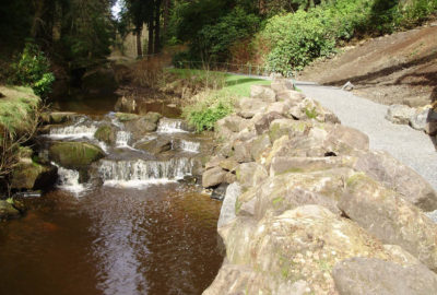 Rocky river wall next to path